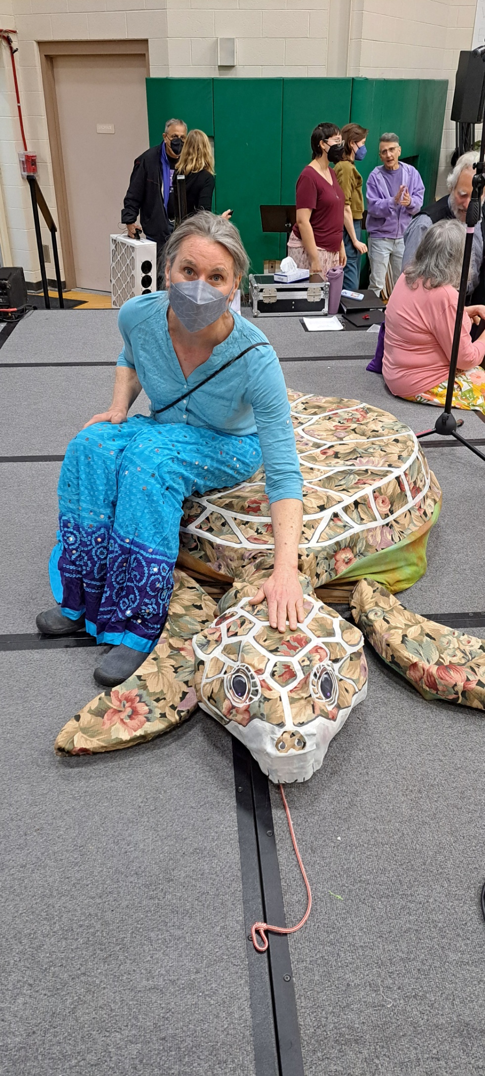 Brie sitting on turtle puppet